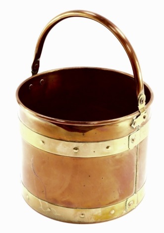 A copper and brass bound fire bucket, 23cm high, 39cm wide.