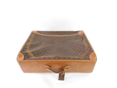 A Louis Vuitton style leather and canvas suitcase, single compartment with a side curved opening zip, 66cm wide. - 2