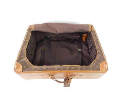 A Louis Vuitton style leather and canvas suitcase, single compartment with a side curved opening zip, 66cm wide. - 3