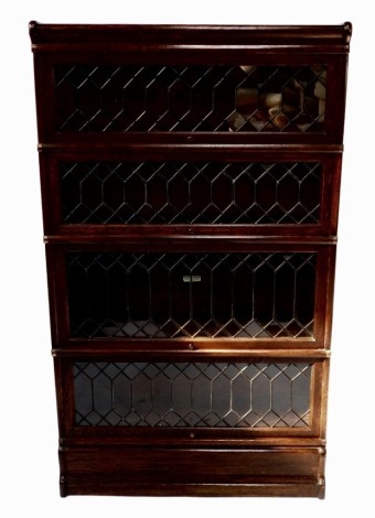 A Globe Wernicke oak four section bookcase, with astragal glazed up and other doors, raised on a plinth base, 147cm high, 86.5cm wide, 31cm deep.