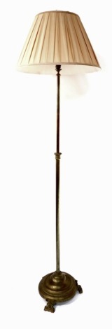 A Victorian brass telescopic standard lamp, with a silk shade, 185cm high extended.