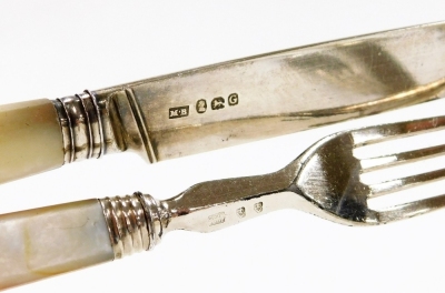 A silver and mother of pearl handled ten piece knife and fork set, the knife ends and blades being silver, maker MB, London assay, the forks plated, in material sleeve. - 3