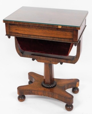 A Victorian rosewood sewing table, with side slide drawer and red velvet draw bag on a quatrefoil base, terminating in bun feet, 73cm high, 55cm wide, 36cm deep.