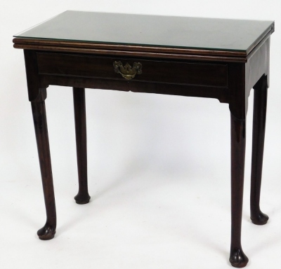 A George III mahogany side table, with fold over top and frieze drawer, on turned legs with pad feet, 71cm high, 75cm wide, 38cm deep.