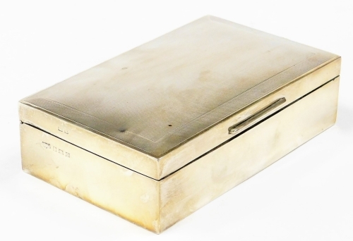 An Elizabeth II silver cigarette box, with engine turned top and cedar fitted interior, Birmingham 1961, 16.5cm x 10cm, 20½oz gross.