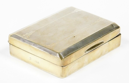 A George V silver cigarette box, with engine turned decorated top and a cedar interior, Birmingham 1931, 12cm x 9cm, 9¾oz gross.