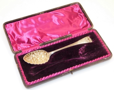 A George III silver berry spoon, the curved handle with foliate detailing, London 1786, 2½oz, in later case.