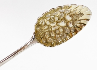 A George III silver berry spoon, the curved handle with foliate detailing, London 1786, 2½oz, in later case. - 2