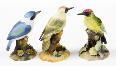 Three Royal Crown Derby boxed bird ornaments, to include green woodpecker, 15cm high, in matte finish, a glazed woodpecker, 15cm high, and a matte finish kingfisher, 13cm high. (3) - 3