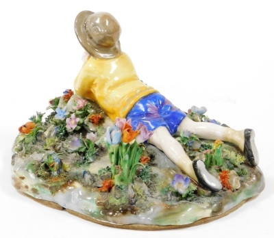 A Royal Staffordshire figure group, of a boy lying in flower garden, modelled by Bagley, with green stamp to underside and partially rubbed label, 24cm wide. - 2