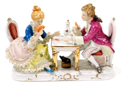 A Continental porcelain figure group, of card players in 18thC dress seated at a table, 26cm wide.
