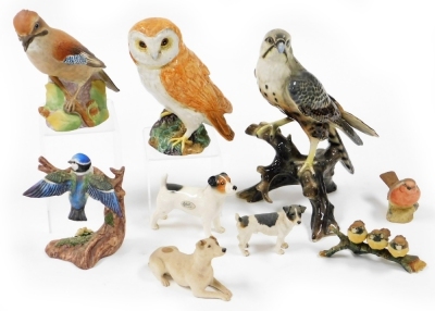 A group of various animal ornaments, to include a Capodimonte figure of three birds on a branch, an Aynsley robin, a Renaissance blue tit figure group a Sylvac dog, a large Beswick owl, a Royal Worcester jay and a large figure of a bird perched on a branc