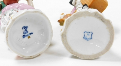 A group of Continental porcelain figures, some Dresden, to include a Dresden figure of a female playing mandolin 13cm high, a pair of girl and boy with dog figure groups 15cm high, a figure of a child playing flute (AF) 11cm high stamped Dresden, and thre - 4