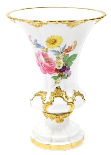 A Meissen vase, the flared rim top with gilt decoration and hand painted floral decoration on a fluted base, blue cross swords mark to base, 24cm high.