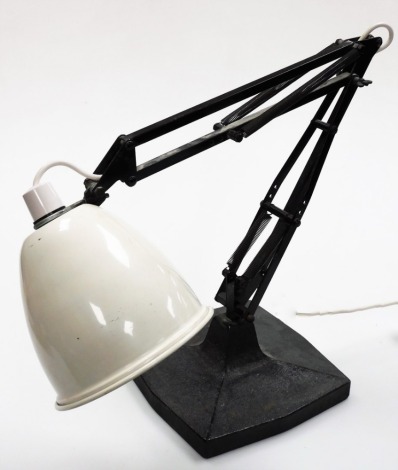 An anglepoise desk lamp, with a cream shade on black base and arched leaver movement, 41cm high when closed.