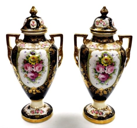 A pair of Noritake two handled vases and covers, each on a black ground with floral gilt detailing, and painted detail of flowers, 40cm high.