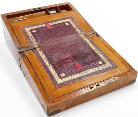 A figured walnut campaign writing box, with brass inlay and a red leather inset interior, 16cm high, 30cm wide, 22cm deep.