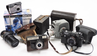 A group of camera equipment, to include a Pentax Optio S5I, Kodak box camera, a Keystone Electric Eye K-4C, a Carina Computer, a Nomo Cosmic Symbol and a Praktica Prinz Galaxy 1-4.5 lens.