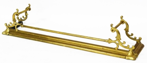 A Victorian Art Nouveau brass fire curb, of D end form, with elaborate scroll top and cylindrical central horizontal section, 29cm high, 134cm wide, 27cm deep.