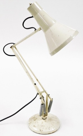 A cream angle poise lamp, 85cm high when fully extended.