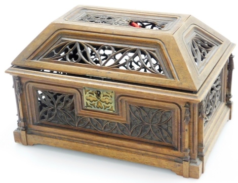 A Victorian fretwork carved walnut gothic casket, the top bearing the initials ES, with key lock and carved Boudin Scu'p, 9 Rathbone Place, London to base, 19cm high, 26cm wide, 17cm deep. (AF)