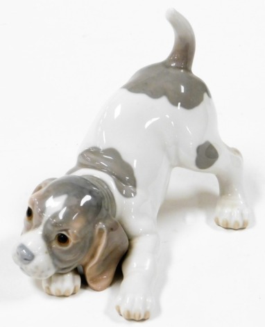 A Lladro model of a playing puppy, 12cm high.