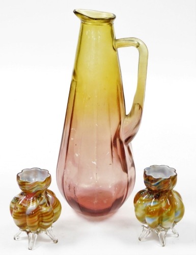 A group of Art Glass, to include a pair of flared vases, 12cm high, and a yellow and red water jug, 39cm high. (3)