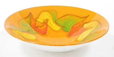 A Poole pottery Delphis bowl, on orange ground with fruits border, 27cm wide.