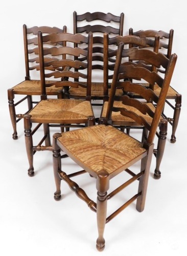 Six rush seated and oak framed dining chairs, to include one carver, each with five panelled back. (6)