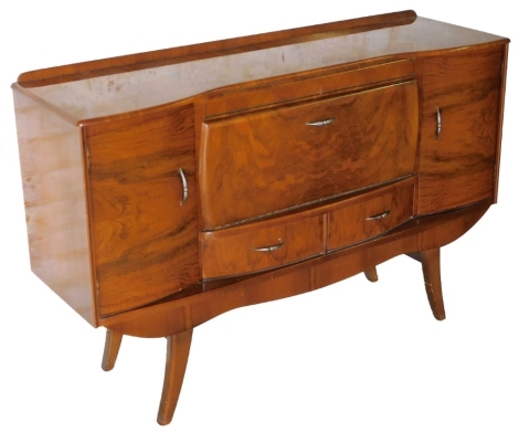 A vintage 1960/70s sideboard, the centre with cocktail cabinet section above two doors and two cupboards, on a curved frontage, on splayed legs, 90cm high, 138cm wide, 42cm deep.