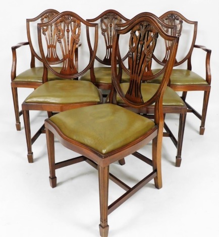 A set of six mahogany dining chairs, with Prince of Wales feather splats and green leather drop in seats, comprising two carvers, 100cm high, 43cm wide, 46cm deep, with Shaw of London retailers stamp. The upholstery in this lot does not comply with the 19