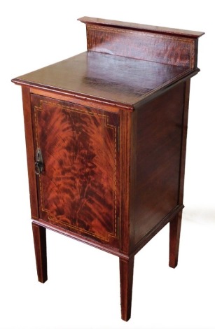 A Victorian mahogany pot cupboard, with string inlay detail on the legs and door, on taper legs, 82cm high, 40cm wide, 36cm deep.