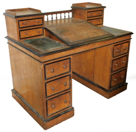 A Victorian oak banker's desk, with ebonised mouldings to the raised upper section and the drawer cockbeading, with knob handles and plinth bases with castors. (AF)