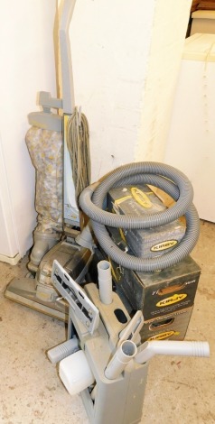 A Kirby upright Micromagic vacuum cleaner, with carpet shampoo system, floor care system and turbo accessory system, together with various accessories. (a quantity)