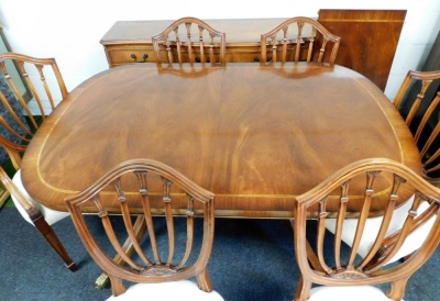 A mahogany dining room suite, comprising a twin pedestal dining table, with additional leaf and marquetry outer banded border, 77cm high, 144cm wide, 99cm deep, together with a set of six chairs, two carvers, each with shield back on a cream floral uphols - 2