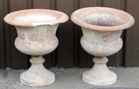 Two Victorian terracotta garden urns, each with flared bowl on tapered stem base, 55cm high. (AF)