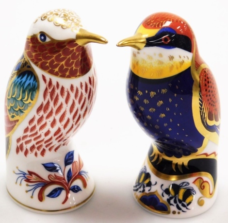 Two Royal Crown Derby paperweights, to include the bee eater, and another bird with red breast, each with silvered button, 10cm high.