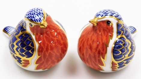 Two Royal Crown Derby paperweights of robins, one with silver stopper and one with gold stopper, 7cm high. (2)