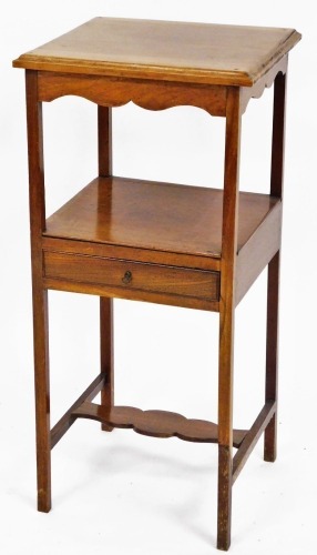 A mahogany night table, the square set top above tiered section with single drawer and splat, on tapered legs, 82cm high, 38cm x 38cm.