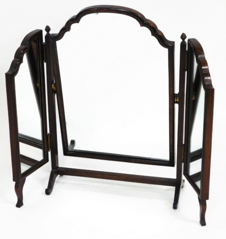 A 1920's walnut veneered triple dressing table mirror, with arched top, on out splayed legs, 63cm high, 45cm wide when closed, 18cm deep.