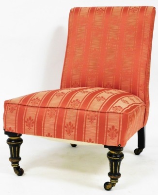 A Victorian aesthetic nursing chair, with parcel gilt ebonised flute legs.