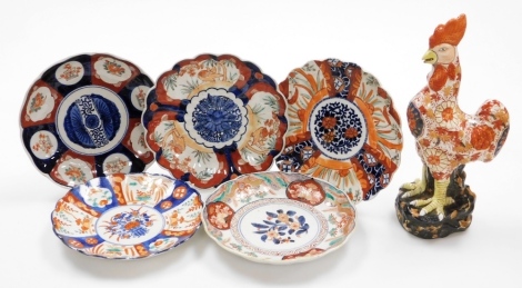 A Japanese Imari plate, decorated in enamels with floral roundels between phoenix, the reverse with prunus sprays and Fuki Chosun mark, 18thC, together with four further Imari plates with flora decoration, Meiji period and a later Kutani rooster. (6)