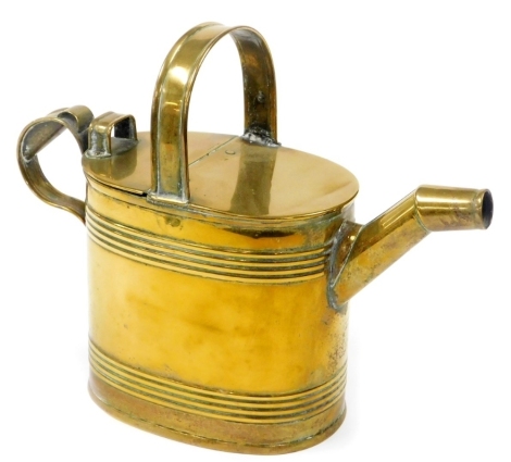 A Victorian brass watering can, 24cm high, 31cm wide.