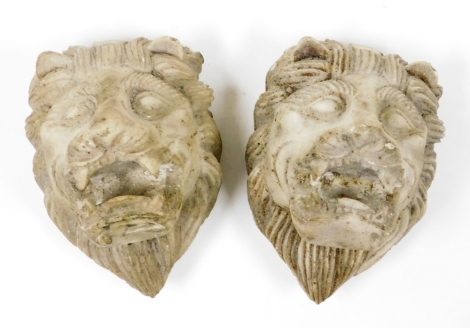 Two resin lion masks, 12cm high.