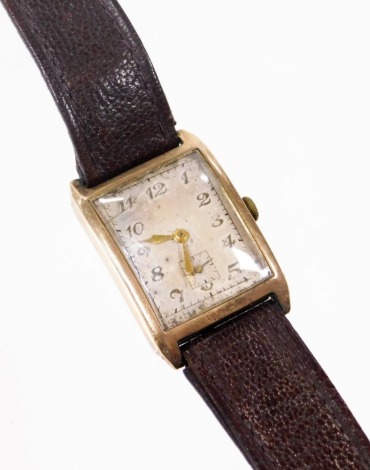 A gentleman's 9ct gold cased Rolex tank wristwatch, with rectangular watch head on a silvered dial with seconds dial, numbered 556 63215, on a brown leather strap, the dial 2.5cm x 3cm, 23.7g all in.