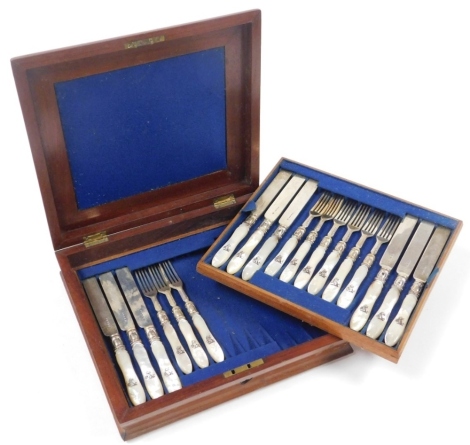 A cased set of twelve Victorian mother of pearl handled knives and forks, each with silver blades, maker stamp JG, Birmingham 1862, incomplete, three knives and three forks missing, in a mahogany cased with engraved crest, with same symbol as the cutlery