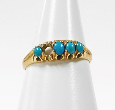 A turquoise dress ring, the gypsy design ring set with five turquoise stones (one missing), in claw setting with rib design shoulders, on a yellow metal band unmarked, possibly 18ct, ring size N, 2g all in, boxed.