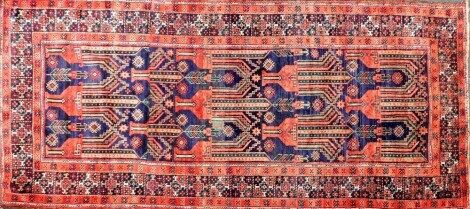 A blue and red ground Turkish design rug, 118cm x 252cm.