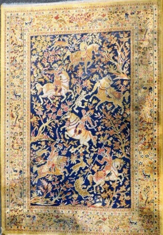 An Indian design rug, with figures on horseback and tigers in the central blue ground field, 132cm x 190cm.