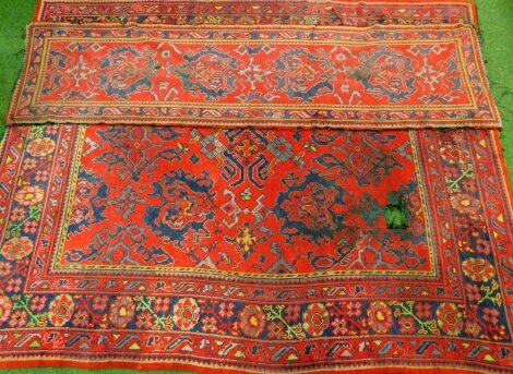 A red ground tufted woollen carpet and runner, red ground. (2)